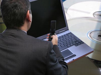 man phone laptop DVDs